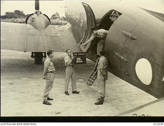 MADANG, NEW GUINEA. C. 1944-10. A BOX OF SPECIAL SOUND RECORDINGS FROM ONE OF THE MAJOR AUSTRALIAN RADIO NETWORKS IS RECEIVED BY 135570 LEADING AIRCRAFTMAN T. C. RICHMOND, NEWCASTLE, NSW, FROM THE ..