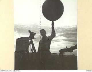 NADZAB, NEW GUINEA. 1944-01-13. PREPARING TO TAKE READINGS FOR METEOROLOGICAL DATA AT NO. 3 AIRSTRIP IN THE EARLY MORNING