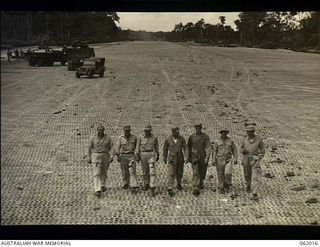 Dreger Harbour, New Guinea. 1943-12-05. The Commanding Officer of the 870th United States Aviation Engineer Battalion, Colonel Marsh, and some of his officers inspecting the new aircraft landing ..