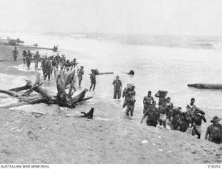 Aitape Sector, New Guinea. 1945-03. Australian troops advancing along the beach towards But, during the Aitape-Wewak campaign