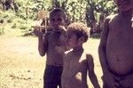 Boy (l) plays a bamboo mouth harp