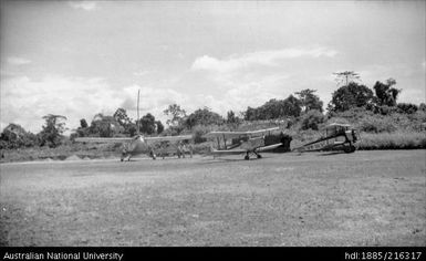 These planes taken at Madang aerodrome, prior to our leaving for Atemble. The large plane on the left is ours. 28 July 1937  12.30 pm  very bright