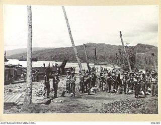 MALAGUNA MISSION, NEW BRITAIN. 1945-09-10. THE BUSY BEACHHEAD SCENE, HALF AN HOUR AFTER THE FIRST TROOPS OF 4 INFANTRY BRIGADE LANDED. THE TROOPS NOW OCCUPY THE RABAUL AREA, FOLLOWING THE SURRENDER ..