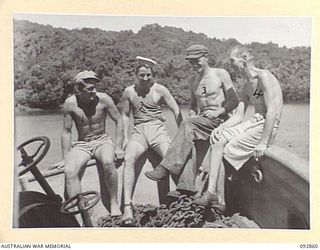 NANTAMBU, NEW BRITAIN. 1945-06. AUSTRALIAN CIVILIANS, MEMBERS OF THE CREW OF AN AMERICAN SMALL SHIP AT NANTAMBU, OPEN BAY