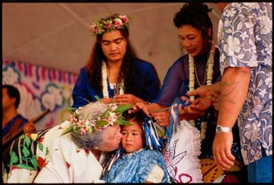 Kayne Lucas Upokokeu has a congratulatory kiss bestowed upon him at his hair-cutting ceremony, Mangere, Auckland