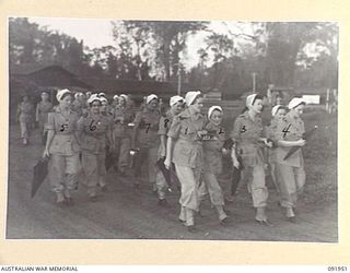 TOROKINA, BOUGAINVILLE, 1945-04-18. MEMBERS OF AUSTRALIAN ARMY NURSING SERVICE FROM 2/1 GENERAL HOSPITAL DAY STAFF GOING ON DUTY AT 0700 HOURS. (7 O'CLOCK). IDENTIFIED PERSONNEL ARE:- SISTER R.K. ..