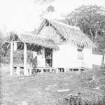 Two men on porch of small dwelling, New Guinea?, c1924 to ?