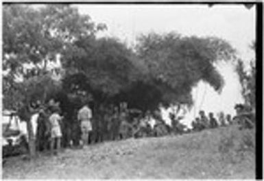 Church service in Kwiop: Solomon Islander mission workers read to Kwiop people, children lined up in front of them