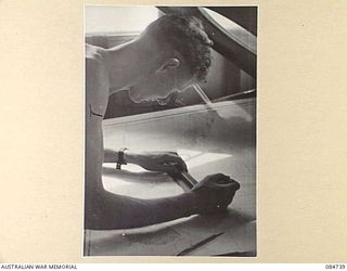 MADANG, NEW GUINEA. 1944-11-06. SUB- LIEUTENANT J K SULLIVAN, GUNNERY OFFICER, CONSULTING THE CHART ON THE BRIDGE ABOARD HMAS STAWELL