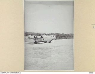 WEWAK, NEW GUINEA. 1945-10-26. A LIBERATOR AIRCRAFT, THE FIRST PLANE OF ITS KIND TO LAND AT BORAM AIRSTRIP, ARRIVING WITH GENERAL SIR THOMAS A. BLAMEY, COMMANDER-IN-CHIEF, ALLIED LAND FORCES, SOUTH ..