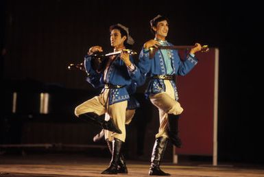 Two Chinese People's Liberation Army Air Force Song and Dance Troupe dancers perform at the Waikiki Shell. The troupe is here on the final stop of its US tour