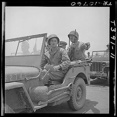 Lt. Gen. Holland M. Smith (right) USMC takes jeep tour of Saipan airfield.