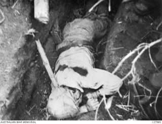 ORODUBI, NEW GUINEA. 1943-07-29. THE BODY OF ONE OF MANY DEAD JAPANESE KILLED ON "TIMBERED KNOLL", AFTER THE SUCCESSFUL ATTACK ON THE JAPANESE STRONGHOLD BY 2/3RD AUSTRALIAN INDEPENDENT COMPANY. ..