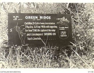 FINSCHHAFEN AREA, NEW GUINEA, 1944-03-17. ONE OF MANY BATTLE SIGNS IN THE AREA, THIS SIGN RECORDS ACTIVITIES OF THE 2/48TH INFANTRY BATTALION, AND THE 2/2ND MACHINE GUN BATTALION IN THE BATTLE FOR ..