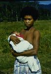 Orokaiva woman holding a baby, 1959?