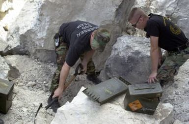 United States Air Force (USAF) MASTER Sergeant (MSGT) Larry Senst and SENIOR AIRMAN (SRA) Adam Ginett of the 36th Explosive Ordnance Disposal (EOD) flight, Andersen Air Force Base (AFB), Guam, prepare to detonate ordnance on the Tarague EOD range