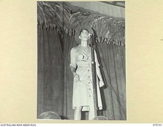 LAE, NEW GUINEA. 1944-08-11. "WINNIE, THE WAR WINNER", A FEMALE IMPERSONATOR, PUTTING ON AN ACT DURING A CONCERT STAGED BY THE WHITE HORSE INN CONCERT PARTY FOR PATIENTS OF THE 113TH CONVALESCENT ..