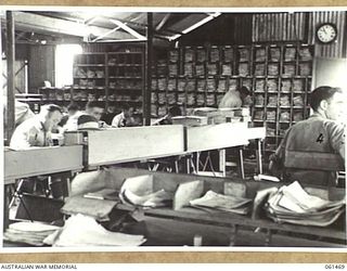 PORT MORESBY, NEW GUINEA. 1943-12-06. STAFF AT WORK IN THE CONTROL OFFICE OF NO. 2 SUB DEPOT, 10TH AUSTRALIAN ADVANCED ORDNANCE DEPOT. IDENTIFIED PERSONNEL ARE: NX116858 SERGEANT A. JONES (1); ..