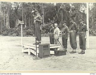 TOROKINA, BOUGAINVILLE ISLAND. 1944-12-06. VX38969 MAJOR-GENERAL W. BRIDGEFORD, CBE, MC, GOC, 3RD DIVISION (1) TAKING THE SALUTE FROM PERSONNEL OF D COMPANY, 15TH INFANTRY BATTALION AS THEY MOVE ..