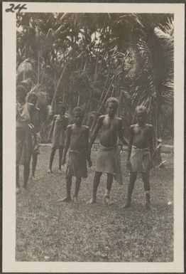 Tolai boys, boy in centre is wearing a crucifix, New Britain Island, Papua New Guinea, approximately 1916