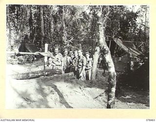 BOUGAINVILLE ISLAND. 1945-01-17. QX6152 BRIGADIER R.F. MONAGHAN, DSO, COMMANDING, 29TH INFANTRY BRIGADE (2) OUTSIDE HIS DUGOUT OFFICE WITH MEMBERS OF HIS STAFF. IDENTIFIED PERSONNEL ARE:- QX6832 ..