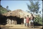 Mai's family in front of their house