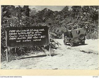 FINSCHHAFEN AREA, NEW GUINEA. 1944-03-13. ONE OF MANY BATTLE SIGNS IN THE FINSCHHAFEN AREA, THIS SIGN RECORDS ACTIVITIES OF THE 2/43RD INFANTRY BATTALION, AND "D" COMPANY, 2/32ND INFANTRY BATTALION