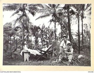 PALMALMAL PLANTATION, JACQUINOT BAY, NEW BRITAIN, 1945-08-14. PATIENTS RELAXING IN THE GROUNDS AT THE 2/8 GENERAL HOSPITAL. THEY ARE PRIVATE C.C. PIPE, 29/46 INFANTRY BATTALION (1); CORPORAL B.J. ..