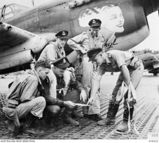 New Guinea. 1943. Kittyhawk fighter pilots after a successful mission. Left to right: Flight Sergeant K. Jago of Sydney, NSW; Pilot Officer (PO) N. Bill of Darwin, NT; PO C. Scott of Goulburn, NSW; ..