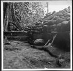 Trench behind ahu of coastal marae site 129 looking from E-W corner stone at lower right. Showing base stones E-W