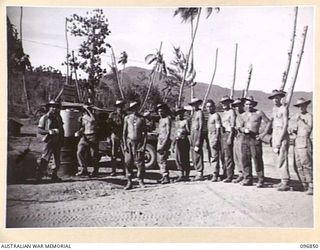 MALAGUNA, NEW BRITAIN, 1945-09-20. TROOPS OF 11 INFANTRY BATTALION, 13 INFANTRY BRIGADE, LINE UP FOR A CUP OF TEA SUPPLIED BY THE SALVATION ARMY AND THE AUSTRALIAN COMFORTS FUND AT THE BEACH. ..