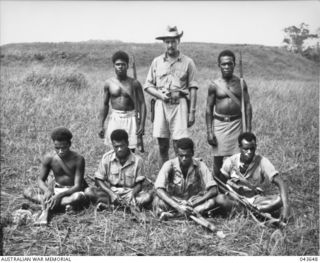 GUADALCANAL, 1942-10. CAPT MARTIN CLEMENS, SOLOMON ISLANDS DEFENCE FORCES, PICTURED WITH NATIVE POLICEMEN. CAPT CLEMENS REMAINED ON GUADALCANAL THROUGHOUT THE JAPANESE OCCUPATION. (DEFENCE ..