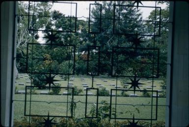 Bomana Cemetery, through a wrought iron window (towards the left) : Port Moresby, Papua New Guinea, 1953 / Terence and Margaret Spencer
