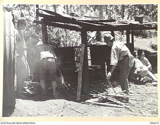BONIS PENINSULA, BOUGAINVILLE. 1945-09-15. JAPANESE COOKHOUSE AT THE JAPANESE NAVAL HEADQUARTERS, BONIS PENINSULA, SHOWING NAVAL TROOPS IN PROCESS OF PREPARING A MEAL. AN AUSTRALIAN SURRENDER ..