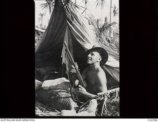 LOS NEGROS ISLAND, ADMIRALTY ISLANDS. 1944-03-18. LEADING AIRCRAFTMAN C. A. PHILP, SURREY HILLS, VIC, KEEPS A CLOSE WATCH FOR ENEMY AIRCRAFT. THE FIRST TWO NIGHTS AIRMEN OF THE RAAF KITTYHAWK ..