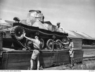 1942-10-19. ONE OF THE JAPANESE TYPE 95 HA-GO LIGHT TANKS THAT WERE PUT OUT OF ACTION BY THE AUSTRALIANS AT MILNE BAY BEING EXAMINED BY OFFICERS BEFORE BEING SENT ELSEWHERE FOR FURTHER EXAMINATION. ..