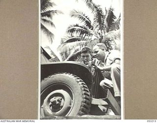 MILNE BAY, NEW GUINEA. 1943-06-26. QX52592 DRIVER W.L. LAVERACK-ROBINSON (LEFT) AND QX37976 SERGEANT A.E. SMITH, OF THE TRANSPORT SECTION, 5TH AUSTRALIAN DIVISION, DOING MAINTENANCE ON A JEEP