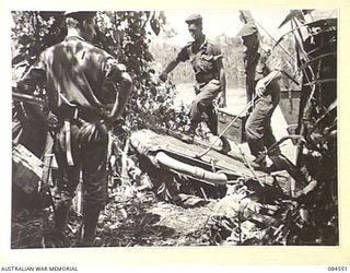 JABA RIVER AREA, BOUGAINVILLE, SOLOMON ISLANDS. 1944-12-18. D COMPANY, 15 INFANTRY BATTALION LANDING FROM A BARGE AT THE SOUTH BANK OF THE RIVER DURING THEIR MOVEMENT TO ESTABLISH NEW POSITIONS. ..