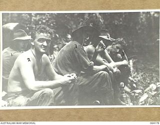 MOUNT PROTHERO, NEW GUINEA. 1944-01-21. PERSONNEL OF THE 2/2ND PIONEER BATTALION RELAXING AFTER A PATROL OF THE MOUNT PROTHERO AREA. IDENTIFIED PERSONNEL ARE:- NX81159 PRIVATE F.C. CHEAL (1); ..