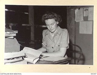 LAE, NEW GUINEA, 1945-05-23. PRIVATE R.F. GOULD, AUSTRALIAN WOMEN'S ARMY SERVICE, AT WORK IN THE REGISTRY ISSUE CONTROL, NUMBER 1 SUB DEPOT, 4 ADVANCED ORDNANCE DEPOT. AUSTRALIAN WOMEN'S ARMY ..