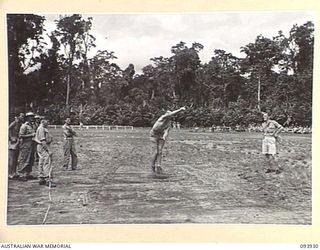 TOROKINA, BOUGAINVILLE, 1945-07-15. PRIVATE F. O'CONNELL, 12 ADVANCED WORKSHOP, COMPETING IN THE SHOT PUTT DURING THE COMBINED ALLIED SPORTS CHAMPIONSHIP MEETING AT GLOUCESTER OVAL ARRANGED BY ..