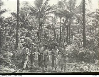 LOS NEGROS ISLAND, ADMIRALTY ISLANDS. 1944-03-18. GUARDS ON PATROL HALT ON AN OVERGROWN TRACK NEAR MOMOTE AIRFIELD. RAAF KITTYHAWK AIRCRAFT WERE OPERATING FROM THE STRIP ONLY FOUR DAYS AFTER THE ..