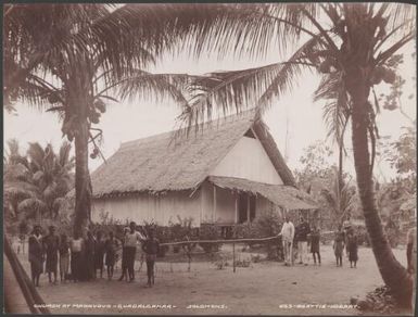 Villagers standing outisde the church at Maravovo, Guadalcanar, Solomon Islands, 1906 / J.W. Beattie