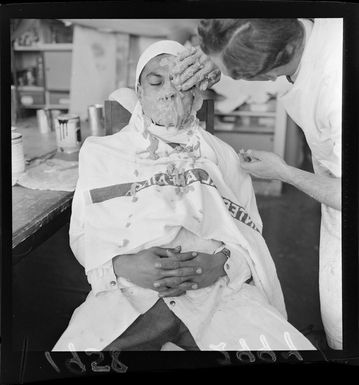 Unidentified Samoan man being prepared for a warrior model