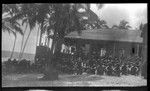 Hookworm lecture in front of a building