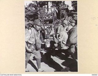 TOROKINA, BOUGAINVILLE. 1945-09-23. JAPANESE NAVAL TROOPS CARRYING PERSONAL GEAR ON A 10-MILE MARCH FROM THE BUKA AREA, ESCORTED BY TROOPS OF 27 INFANTRY BATTALION. ONE OF THE MEN CARRIES A CHAIR. ..