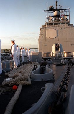 Crew members man the rails aboard the guided missile cruiser USS CHOSIN (CG-65) as the ship passes the USS ARIZONA MEMORIAL during an observance commemorating the 50th anniversary of the Japanese attack on Pearl Harbor