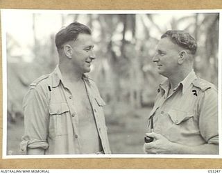 MILNE BAY, NEW GUINEA. 1943-06-29. VX78974 CAPTAIN J. PURDIE DCM (LEFT), COMMANDING OFFICER, "C" GROUP, 2/3RD AUSTRALIAN DOCKS OPERATING COMPANY, ROYAL AUSTRALIAN ENGINEERS, AIF, TALKS TO NX93775 ..