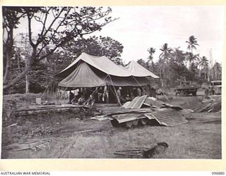 VUNAPOPE, NEW BRITAIN. 1945-09-16. JAPANESE NAVAL GUARDS AT VUNAPOPE MISSION WATCHING THE AUSTRALIAN PARTY COME IN FOR THE EVACUATION OF ROMAN CATHOLIC SISTERS AND PRIESTS FROM RAMALE VALLEY ..