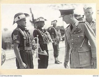 BOUGAINVILLE, 1945-06-13. THE GOVERNOR GENERAL OF NEW ZEALAND, MARSHAL OF THE ROYAL AIR FORCE, SIR CYRIL L.N. NEWALL (1) INSPECTING THE BAND OF THE 7 INFANTRY BRIGADE, DURING A QUICK VISIT TO HQ 2 ..